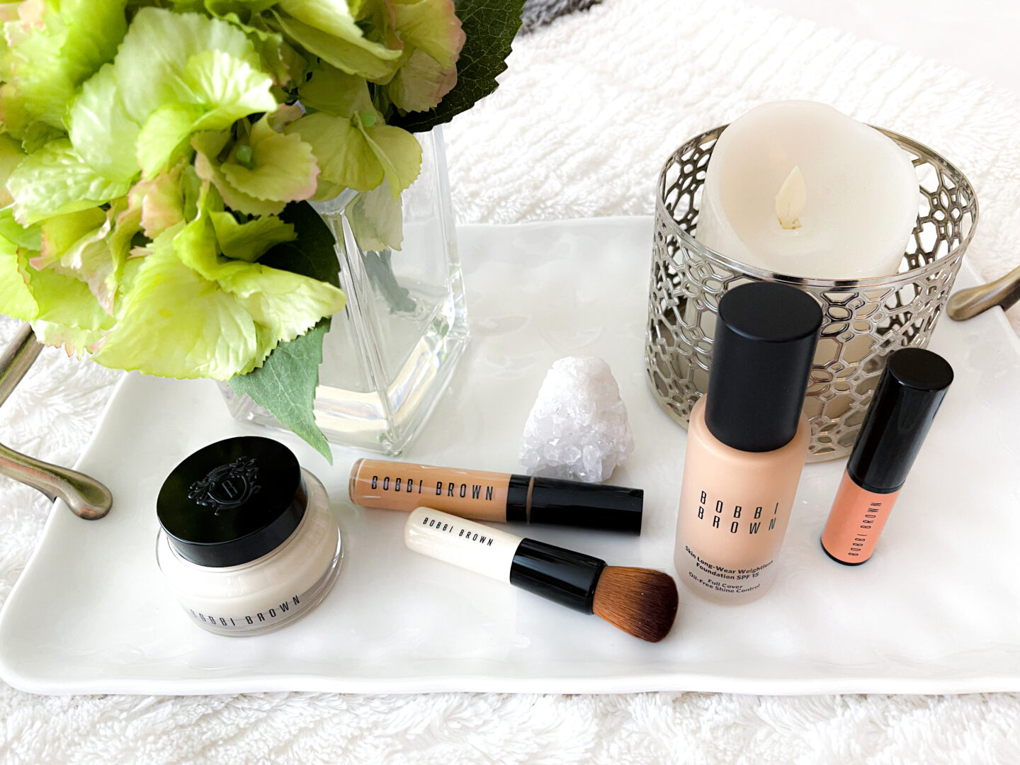 Bobbi Brown Cosmetics Complexion Routine products on bed tray.