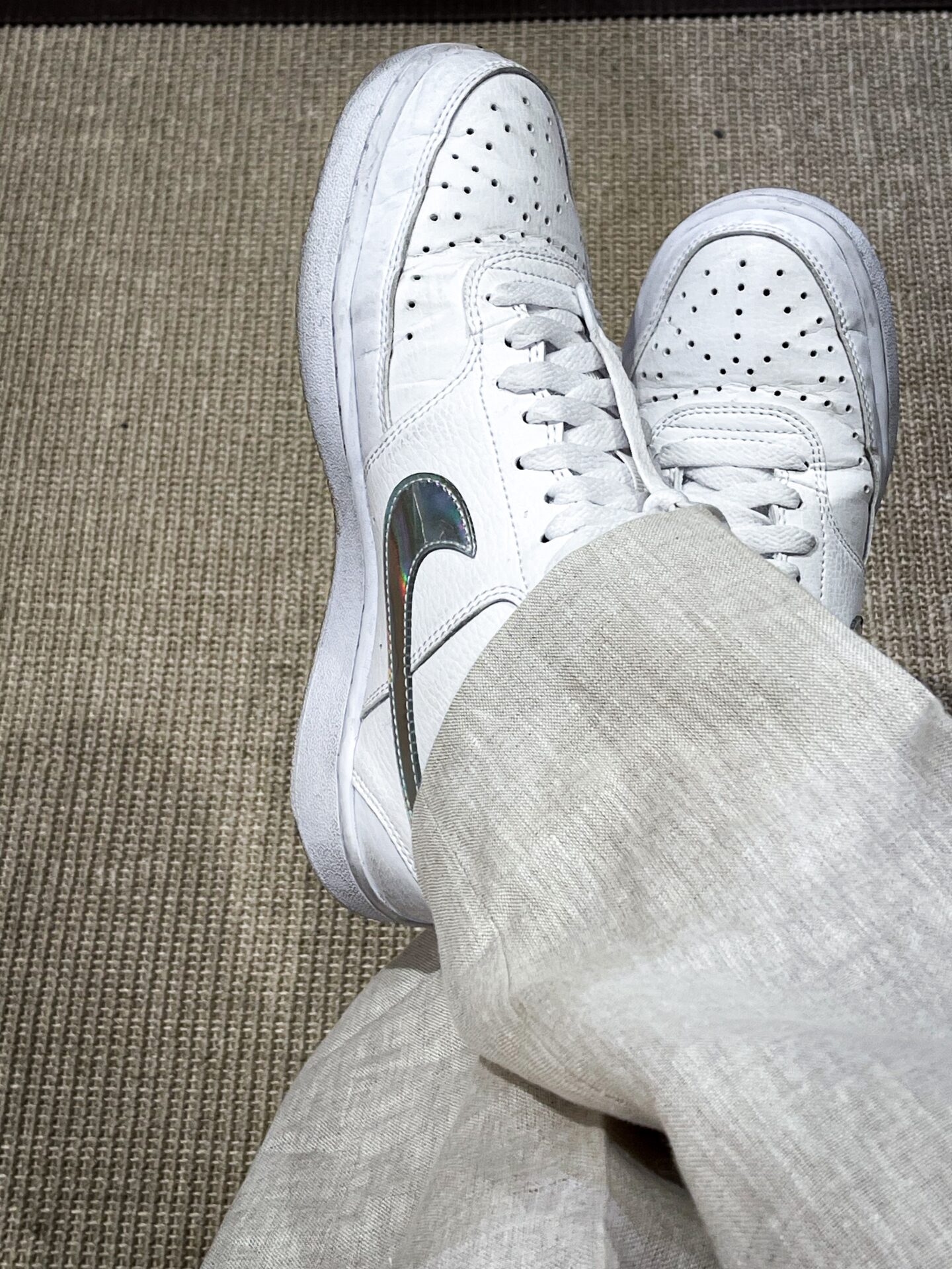 White Nike sneakers with silver swoosh